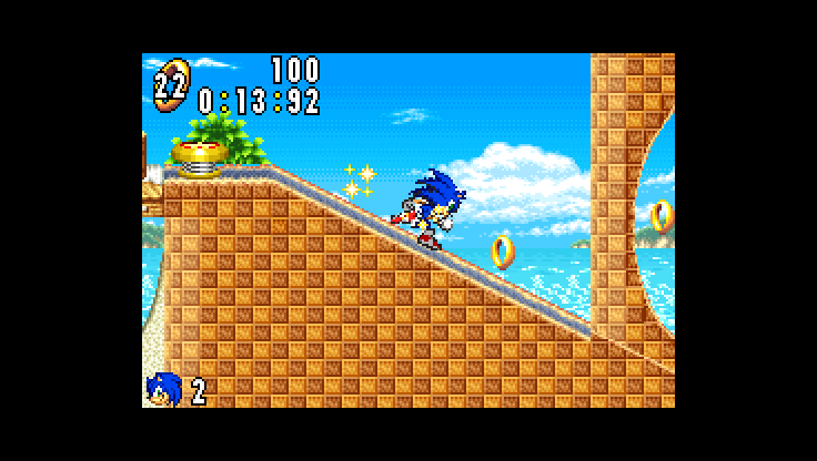 sonic running down a slope toward a loop, in a small screen in the middle of a black frame, with the loop cut off at its right edge