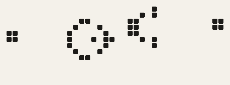 black cells on a pale grid: a block at each end and two larger shapes between them